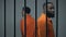 Anxious afro-american and european prisoners on verge of conflict in jail cell