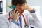 Anxious doctor listens to complaints by phone.