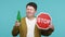 Anxious man showing alcoholic beverage bottle and stop sign, warning and worrying