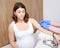 Anxious pregnant woman receiving vaccine injection in arm - pregnancy vaccination concept