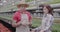 Anxious worried Caucasian man and woman talking in greenhouse between rows of flowers. Portrait of concentrated