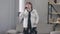 Anxious worried senior Caucasian woman talking on the phone standing in living room indoors. Portrait of stressed female