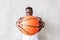 Anxious young athlete gazing and concentrating at basket-ball