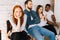 Anxious young woman job candidates looking away while waiting interview with hr sitting in queue line row with bored