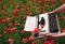 Anzac day. Spring flowers and typewriter with empty paper on blossom field. Remembering.