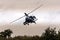 An Apache helicopter flies away to gilze