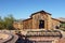 APACHE JUNCTION, ARIZONA - DECEMBER 8, 2016: Apacheland Barn and Model Railroad trestle with the Elvis Memorial Chapel in the back