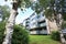 Apartment block building with green lawn and trees