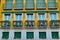 Apartment building facade with balcony flowers Mediterranean style