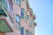 Apartment building with green window frames and corbel roof in San Francisco, CA