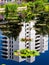 Apartment building reflecting in Monetâ€™s Pool with water lilies in Denver Botanic Gardens on a sunny summer