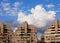 Apartment buildings and clouds above them