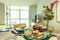 Apartment decorated in pastel colors with a breakfast table with assorted