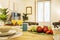 Apartment decorated in pastel colors with a breakfast table with assorted fruits,