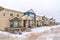 Apartment facade on a winter neighborhood with snow and cloudy sky views