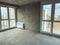 Apartment without finishing and repair. block walls with huge panoramic windows. walls prepared for application of building