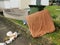 Apartment garbage collection area with old mattress,green dustbin and old sofa.