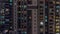 Apartment windows of a glazed skyscraper glow at night with city lights reflection aerial timelapse.