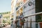 Apartments for rent. Vacation Europe Travel Tourism. A girl in a dress stands near the entrance to a small cozy European hotel.