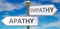 Apathy and empathy as different choices in life - pictured as words Apathy, empathy on road signs pointing at opposite ways to