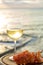 Aperitif cold white wine served in glasses with pink grapes on outdoor tessace witn sea view