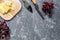 Aperitive parmesan cheese and red grape on grey stone table background copyspace top view