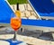 Aperol spritz cocktail at the edge of deck chair. Concepts of drinks, travel, summer and vacation