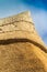 Apex of a freshly thatched cottage roof