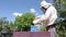 Apiarist, beekeeper is checking bees on honeycomb wooden frame