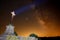 Apocalyptic image of a cross with an orange sky, the Milky Way behind