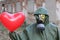 Apocalyptical image with mysterious person holding heart balloon