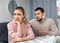 Apologetic husband calming upset wife after spat at home