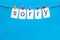 Apologise concept. Cute heart icons garland with text sorry on blue background top view copy space