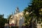 Apostle Church `Parroquia de Santiago Apostol` with tropical plants, old Roman Catholic church with bell tower in Merida, Yucata