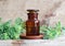 Apothecary bottle with essential wormwood oil extract, tincture, infusion. Old wooden background.