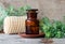 Apothecary bottle with essential wormwood oil extract, tincture, infusion. Old wooden background. Aromatherapy, spa