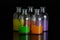 Apothecary, laboratory bottles with colored liquid with reflection