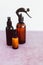 Apothecary skincare bottles and scent spray on pink background, organic ingredients in skincare