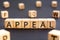 Appeal - word from wooden blocks with letters