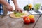 Appealing male hands slicing lettuce