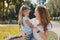 Appealing mother feeling cheerful taking her girl from kindergarten