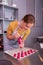 Appealing woman wearing grey apron working with pastry bag