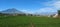 the appearance of green rice fields with a mountain background in the countryside