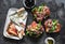 Appetizer, aperitif, snack table - gorgonzola, brie cheese, dried olives, apple, almonds and prosciutto, tomatoes, green salad