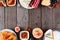 Appetizer of assorted cheeses and meat, top view double border on a wood background with copy space