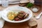 Appetizer from aubergines in a sauce of peppers and tomatoes, served with boiled potatoes. Rustic style, selective focus.