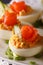 Appetizer beautiful eggs with smoked salmon macro. vertical