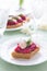 Appetizer with beetroot pesto and slice of herring on festive table
