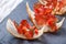 Appetizer bruschetta with jerky prosciutto on thinly sliced ciabatta bread on stone slate background close up.