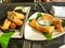 Appetizer chicken spring roll and samosa white plate on table at restaurant. Selective focus. Mock up